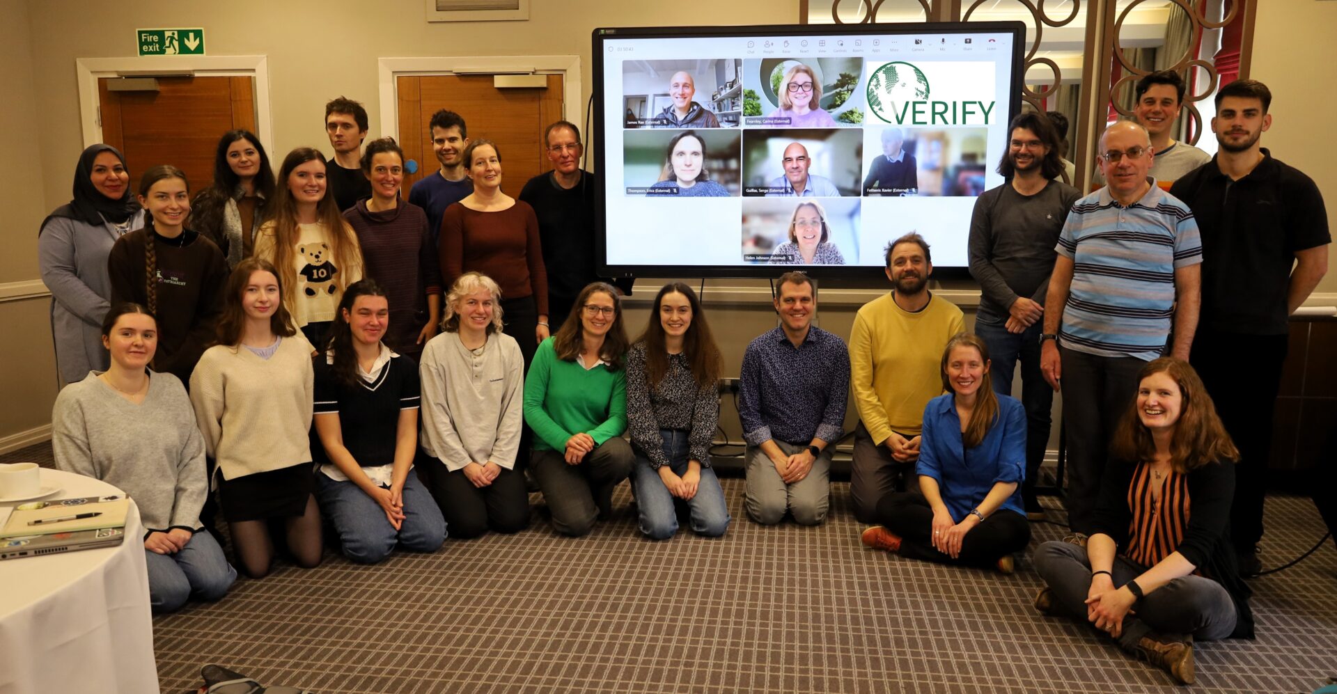 Members of the VERIFY team gather around, smiling at the camera